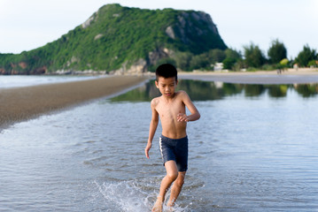 Boy play with a sand on the beach