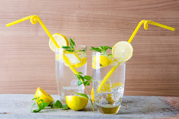 Glasss of mojito with lemon and drinking straw