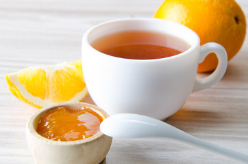Cup of tea served with orange jam