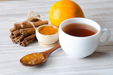 Cup of tea served with orange jam