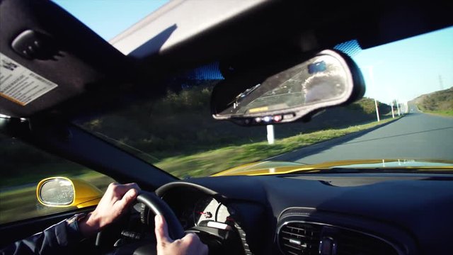 Middle aged man is driving his luxurious cabriolet moving along the morning road in Vladivostok, Russia