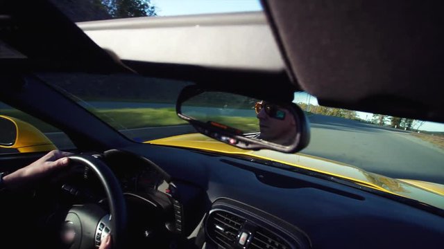 Middle aged man is driving his luxurious cabriolet moving along the morning road in Vladivostok, Russia