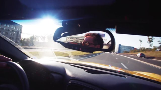 Middle aged man is driving his luxurious cabriolet moving along the morning road in Vladivostok, Russia
