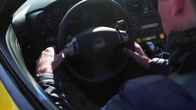 Male hands on luxurious cabriolet  steering wheel
