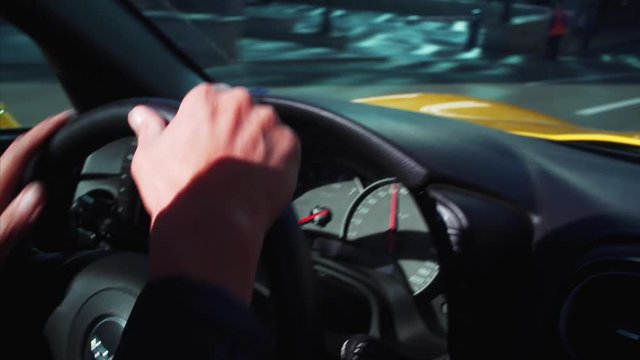 Male hands on luxurious cabriolet steering wheel