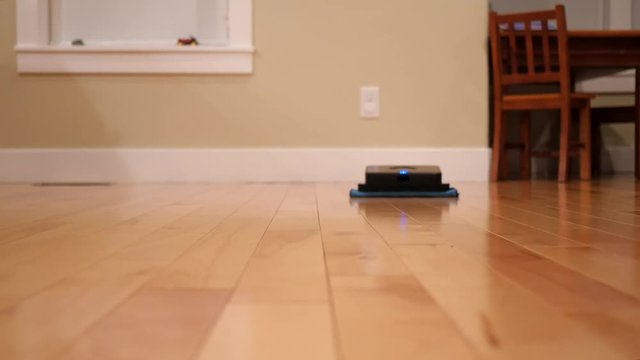 Robot mop cleans the floor inside home