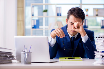 Tired businessman exhausted after hard work and excessive worklo