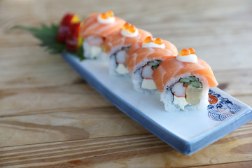 Sushi rolls with salmon on top , Japanese cuisine