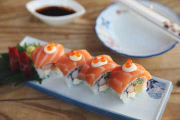 Sushi rolls with salmon on top , Japanese cuisine