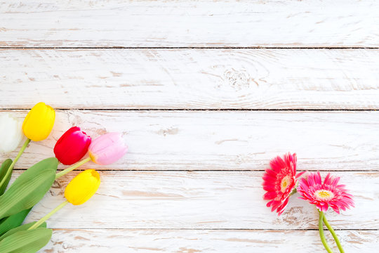 Fototapeta Colorful flowers on vintage wooden background, top view and border design. vintage color tone - flower of spring or summer background