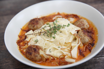 Pasta meatballs tomato sauce on wood background