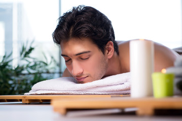 Young handsome man during spa procedure