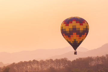 background of the sunset, Silhouette hot air balloon over mountains in sunset sky