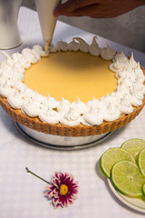 Lemon pie with meringue in decoration process