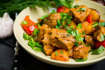 Roasted meat with potatoes, ojaxuri, traditional Georgian food. Selective focus.