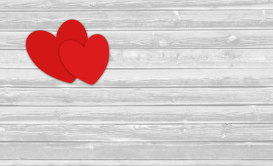 Two red Valentine hearts on white wooden background with blank space for text.
