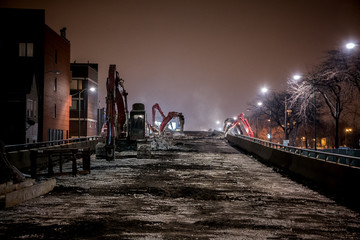 Night construction site of the city of Chicago's Western Avenue viaduct bridge featuring demolition...