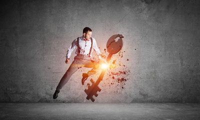 Breaking through access concept with furious man in room crashing concrete key
