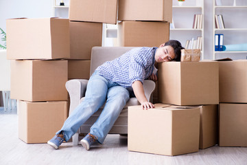 Young man moving in to new house with boxes