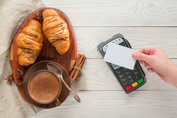 payment through the NFC technology terminal for purchase in a cafe