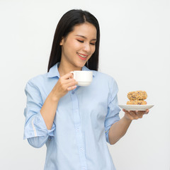 Asian woman holding in female hands donut and drink hot aroma coffee or tea in breakfast time isolated on gray background.