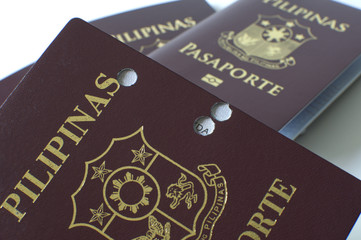 A still life of a old hole-ridden philippine passport