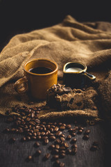 Black coffee Arabica In brown glass And milk and dessert Sack background in low light area