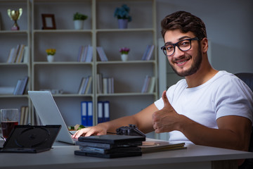 Young man staying late in office to do overtime work