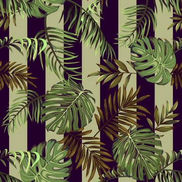 Seamless pattern with leaves of tropical and exotic plants on a striped background