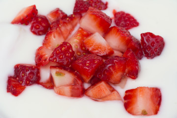 Cut strawberry with natural yogurt close up. macro