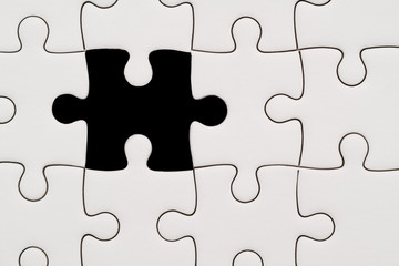 background of white jigsaw puzzle with missing piece