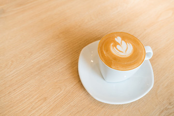 Heart drawing on cappuccino art coffee cup with copy space