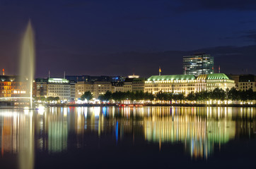 Hamburg Binnenalster at night with Alsterhaus and fountain in the background