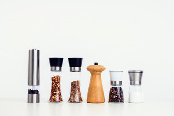 different spice mills with salt,pepper and other herbs