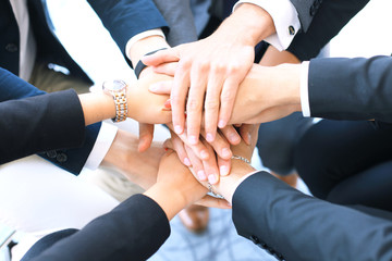 Group of businessman team touching hands together. Selective focus.