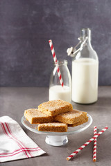 Homemade crumble bars with milk and sugar. Sliced crumb cake on vintage stone table. Healthy dessert. Selective focus. 