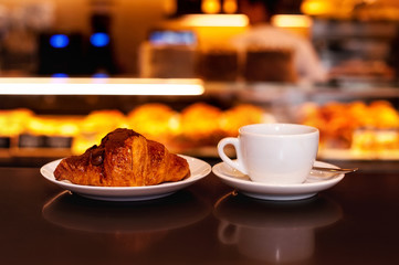 cup of coffee and croissan with chocolate