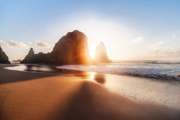 beautiful sandy atlantic ocean beach on sunset. Sintra, Portugal