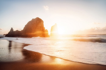 beautiful sandy atlantic ocean beach on sunset. Sintra, Portugal