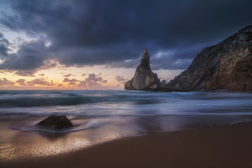 beautiful sandy atlantic ocean beach on sunset. Sintra, Portugal. long exposure