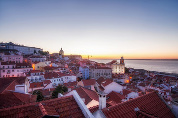 Panoramic view of the city on sunrise. red tiled roofs in Lisbon, Portugal