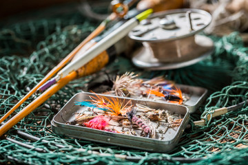Retro fishing tackle with fishing flies and rods