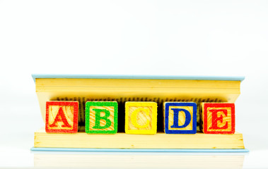 Close up arrangement of alphabet isolated on white background. Preschool, education concept or other your content.