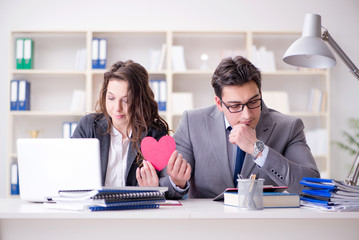 Happy couple working in the same office