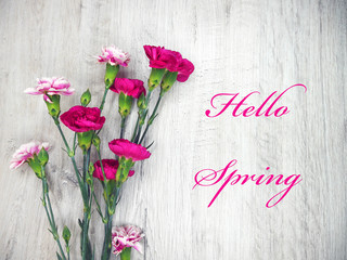 Pink flowers on a light wooden background hello spring