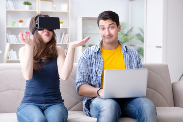 Young family playing games with virtual reality glasses