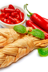 Smoked braided cheese and red pepper on white background