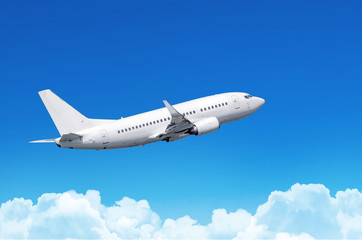 Naklejka na ściany i meble Passenger plane fly on a train above clouds and blue sky.