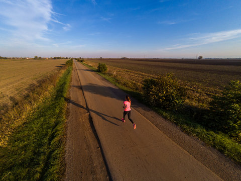 Athletic Woman Running On A Road During Sunset. Shoot Taken With GoPro Hero Black 5.