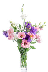 bunch of violet, white and pink eustoma flowers in glass vase isolated on white